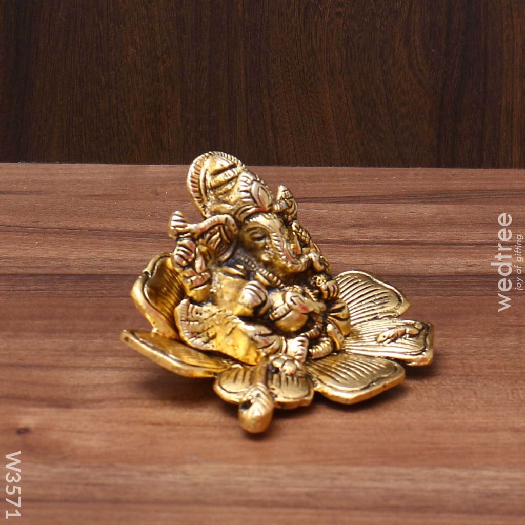 White Metal Ganesha In Flower With Gold Finish - W3571 Divine Return Gifts